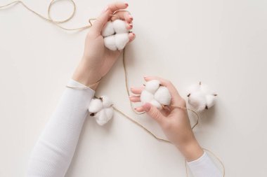 Girl's hand on a white background with the colors of the cotton.