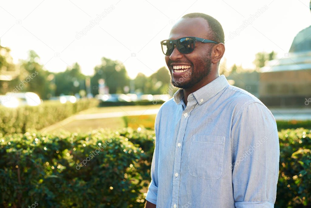 Portrait of an African American businessman. Happy smiling man outdoors .