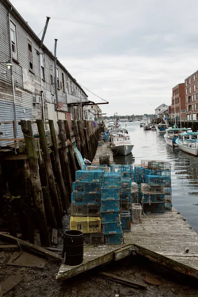 Commercial fishing wharf with stacks of lobster traps in the Old Port Harbor district of Portland, Maine.