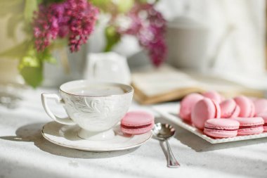 Bir fincan sabah kahvesi, bir kase leylak, hafif arka planda makarna. Kartpostal. Günaydın.