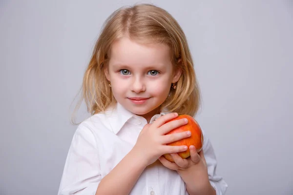 Little Girl Holds Apple Her Hands Smiles White Background — Stock Photo, Image