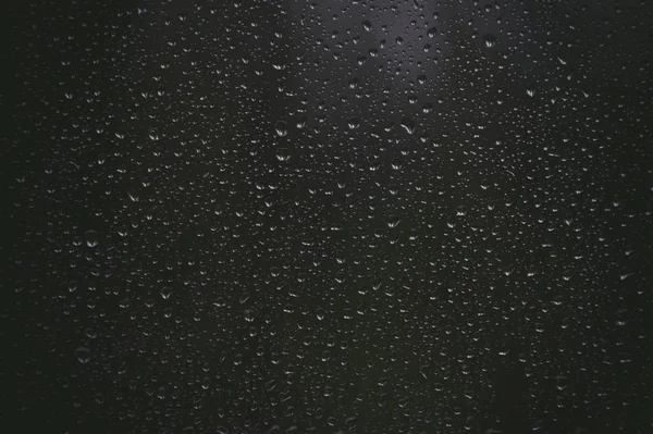 Water raindrops droplets on black background — Stock Photo, Image