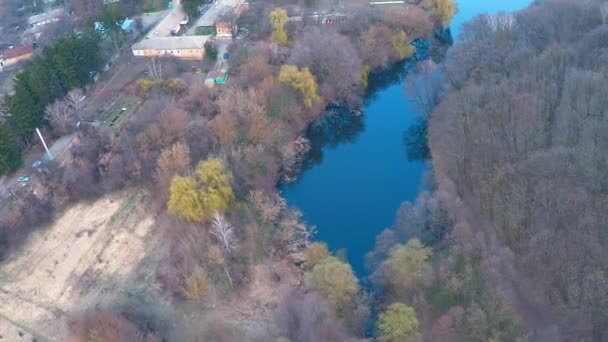 Flying over the monastery near the river in the forest — Stock Video