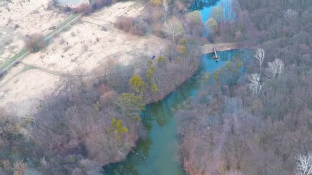 Flying over the river in the forest near the field — Stock Video