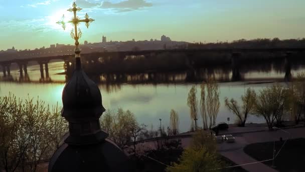 Kiev geniş nehir Dinyeper yakınında büyük bir altın haç ile ahşap bir kilisenin havadan görünümü — Stok video