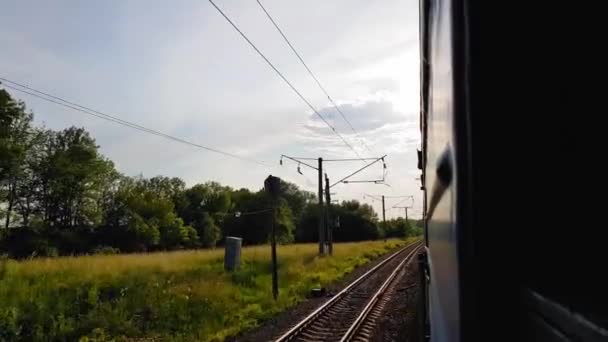 Utsikten från höghastighetståget på den vackra naturen med kullar och skog. Utsikten från fönstret på bilen, buss, tåg. Resa från tåget på en solig dag — Stockvideo