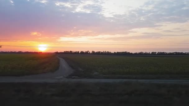 Výhled z vlaku na krásnou scenérii s kopci a lesem po východu slunce. Výhled z okna auta, autobusu, vlaku. Cesta z vlaku. — Stock video