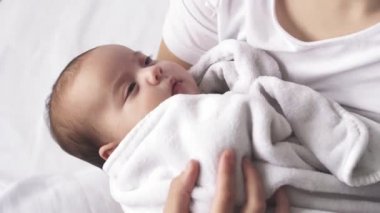 Bebek, annelik, gelişim, çocukluk, pediatri, tıp ve sağlık konsepti - kollarına yeni doğmuş bebeği sarıp sarmalayarak ve çocuğu sakinleştirerek yakın plan genç anne.