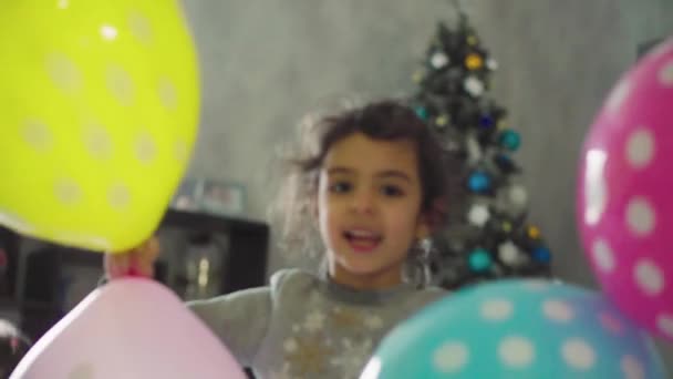Kinderen, viering, verjaardag, grote gezinnen, spelletjes en entertainment concept - jonge kinderen en tieners van verschillende leeftijden en nationaliteiten spelen met ballonnen in ruime kamer tegen het raam. — Stockvideo