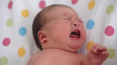 Bebeklik, çocukluk, tıp ve sağlık, pediatri konsepti - hayatın ilk dakikalarında çıplak bebek sırtüstü yatar, döner ve tıbbi cam yatakta ağlar..