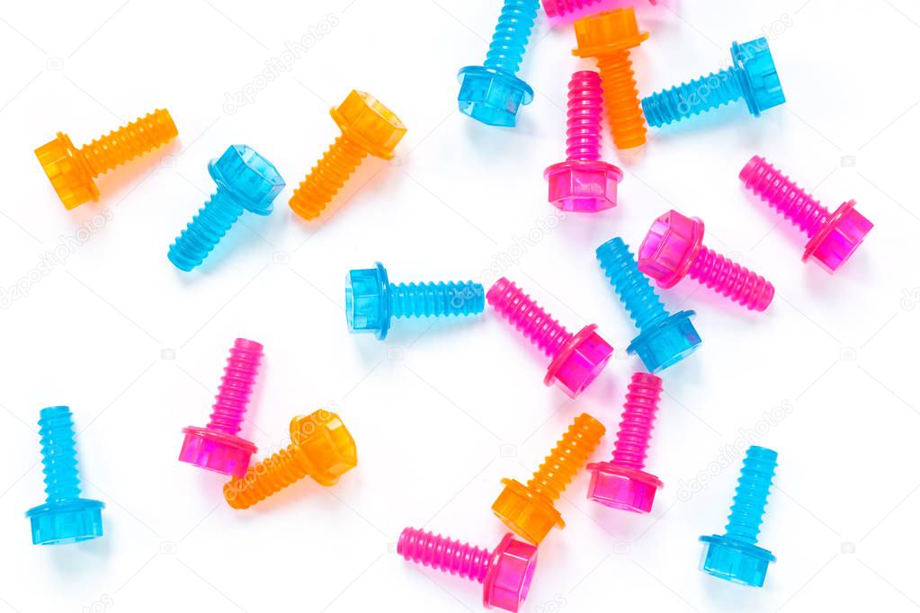 Colored neon translucent plastic toy bolts on white background. Flat lay. Concept World Dad's Day, unisex toys for early development, role-playing games. Layout for social media, toy stores.