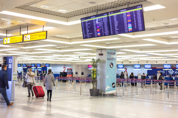 Passengers walking toward check-in counters on Belgrade Airport 