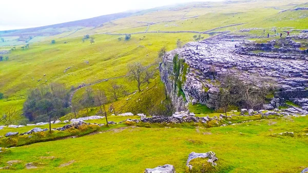 Limestone of cliff and landscape of green gasses in farmland