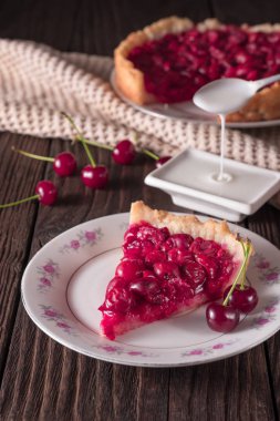 Rustik masada tabakta pişmiş taze vişneli börek dilimi