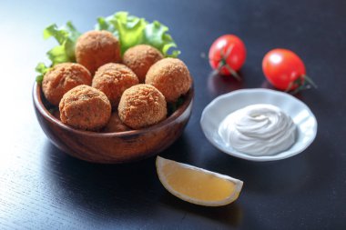 Domates ve sos ile masada kase kızarmış falafel topları