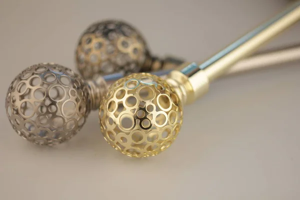 Close-up of curtain poles with ornate spheres endings