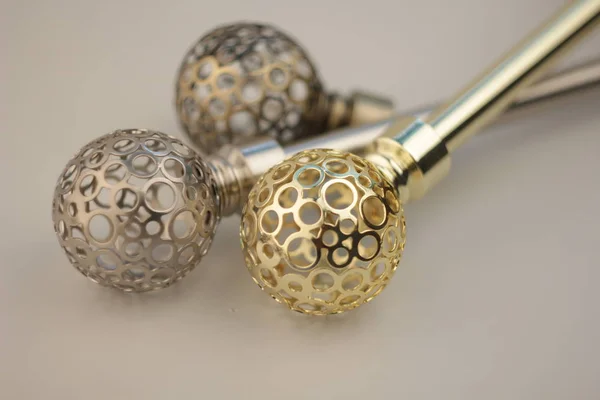 Close-up of curtain poles with ornate spheres endings