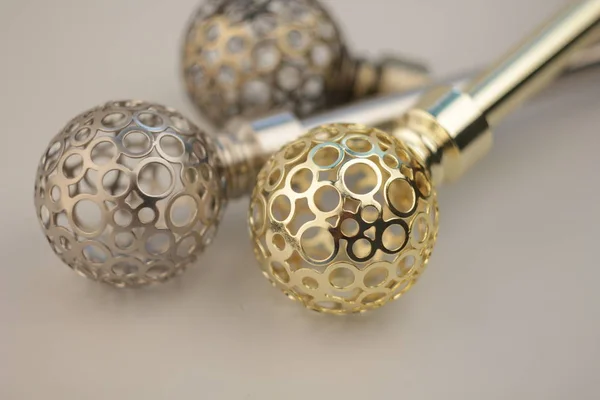 Close-up of curtain poles with ornate spheres endings