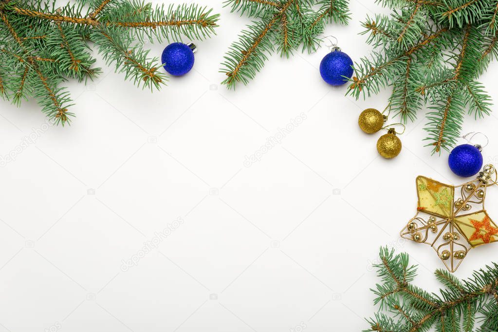 Holiday frame of Christmas decorative fir branches with balls and star baubles on white background