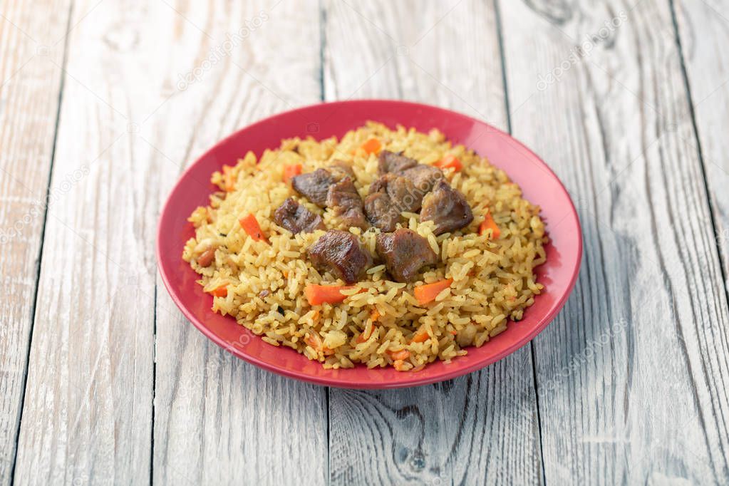 Plate of homemade pilaf dish with meat and vegetables