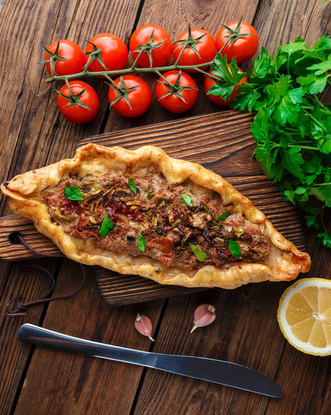 top view of Tasty Turkish pide on wooden table