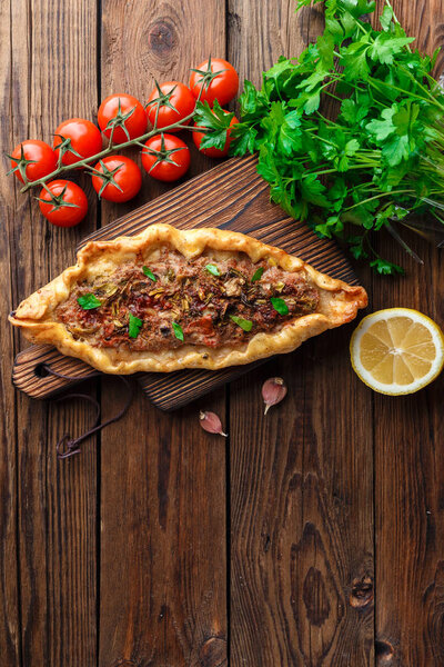 top view of Tasty Turkish pide on wooden table