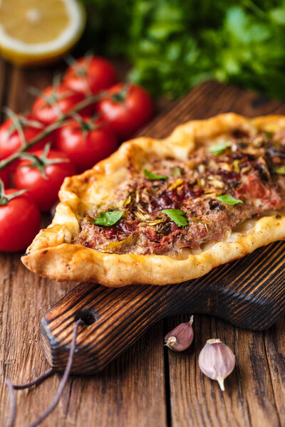 selective focus of Tasty Turkish pide on wooden table