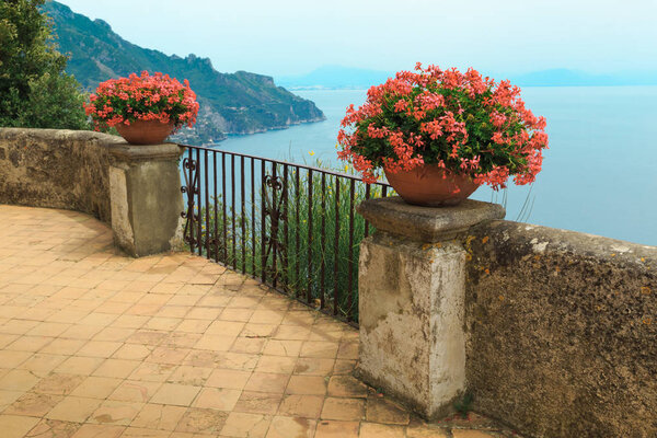 Potted flowers with seascape behind railings in Ravello, Amalfi Coast, Italy