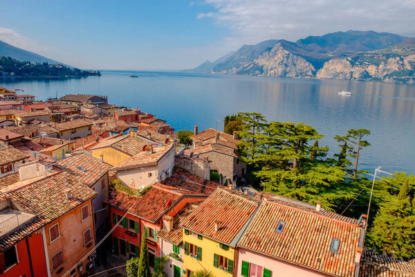 Malcesine cityscape with traditional houses and tiled roofs and lake Garda, Riva del Garda, Italy, Europe