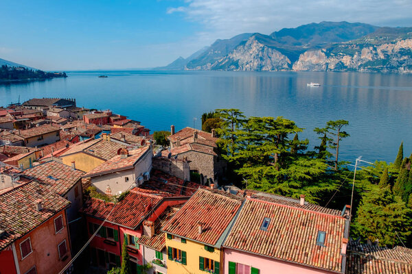 Malcesine cityscape with traditional houses and tiled roofs and lake Garda, Riva del Garda, Italy, Europe
