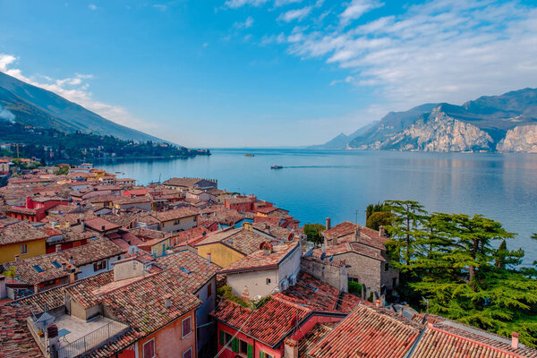 Scenery of Malcesine cityscape with traditional houses and tiled roofs and lake Garda, Riva del Garda, Italy, Europe
