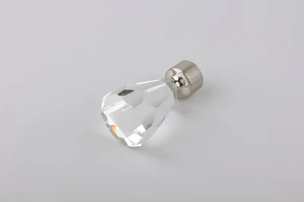 Simple crystal plug for curtain eaves on grey background
