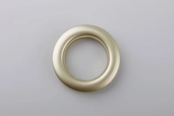 Circular curtain grommet ring for cornice fixing on grey background