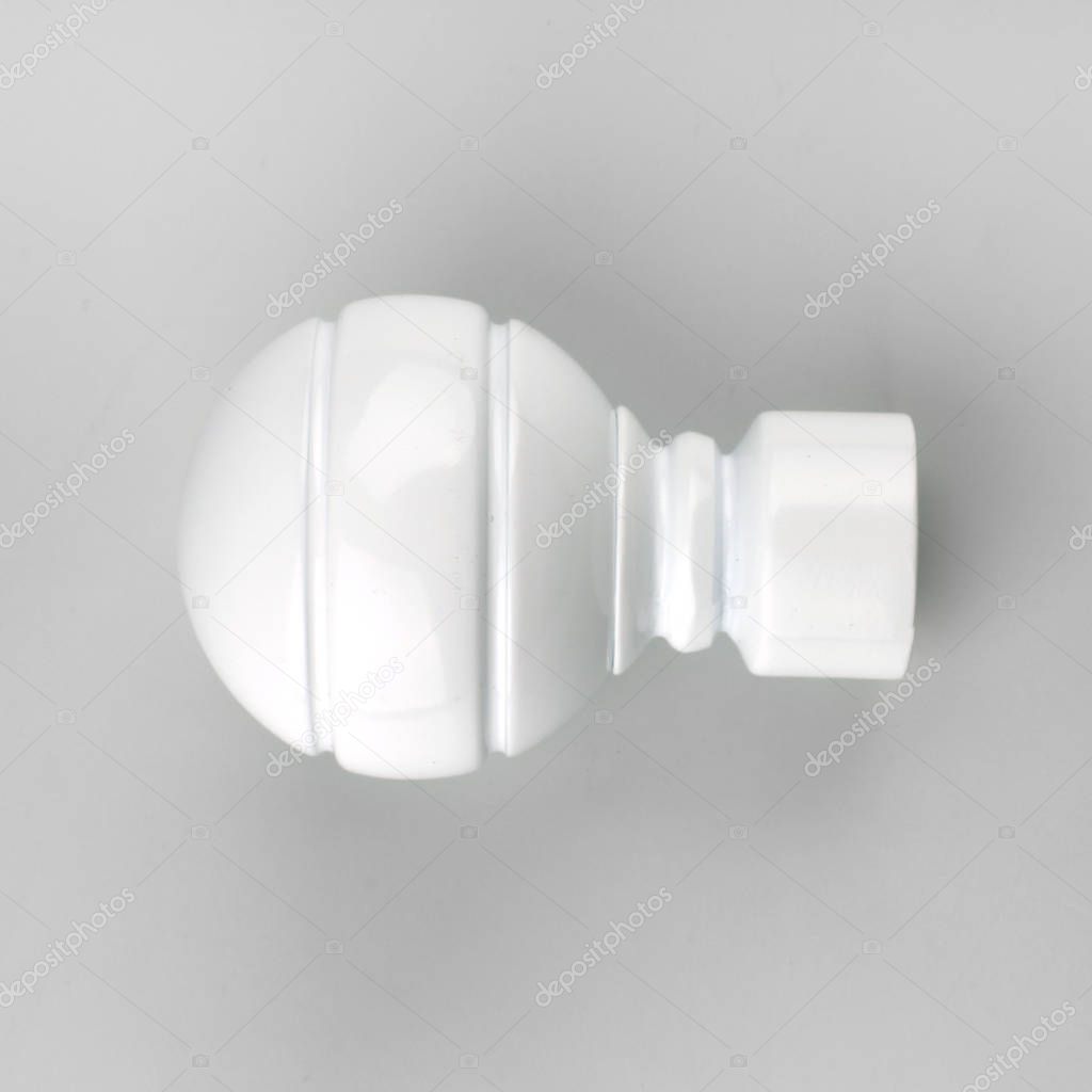 Modern white ball curtain cornice finial on grey background
