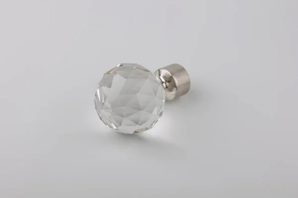 Simple crystal plug for curtain eaves on grey background