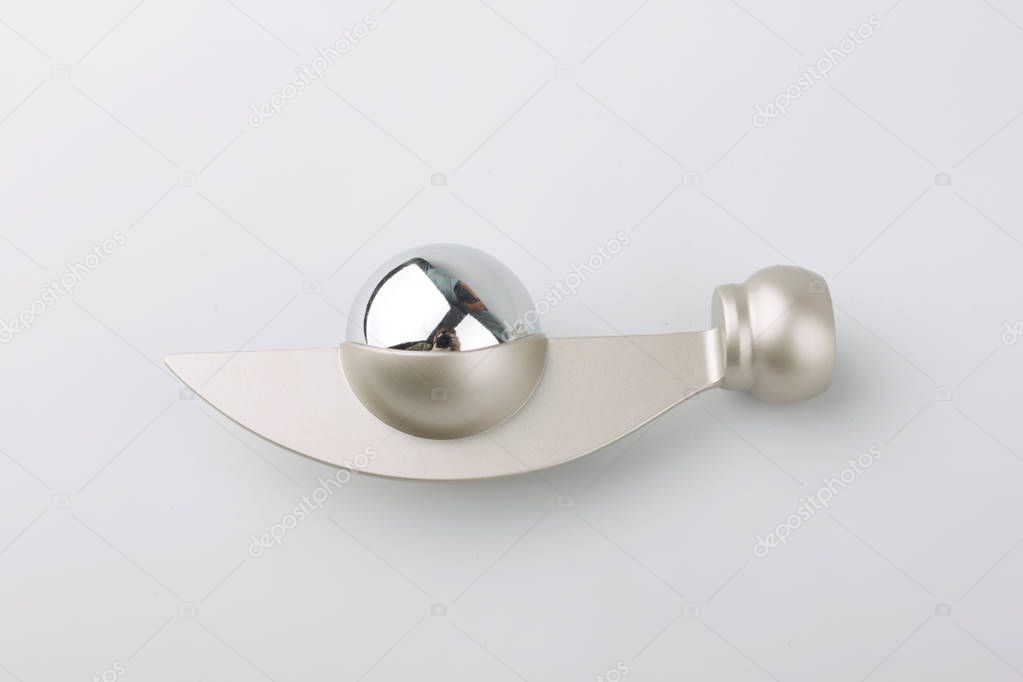 Modern metal ending with ball element for curtain pole on grey background