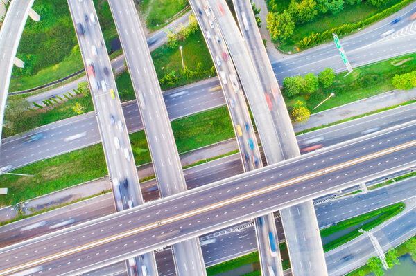 Aerial view car movement on traffic junction road with green tree park, Transport concept