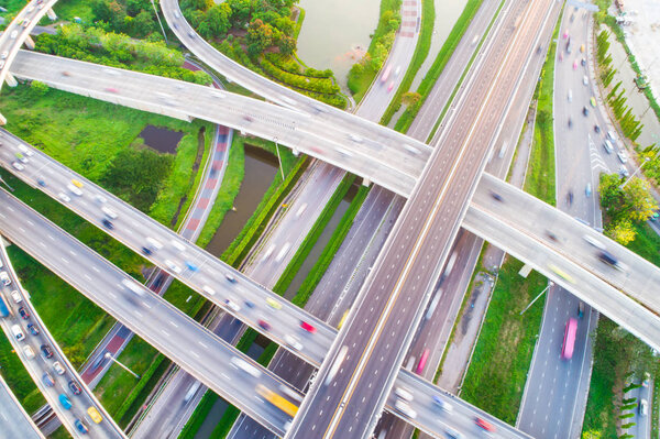 Aerial view car movement on traffic junction road with green tree park, Transport concept