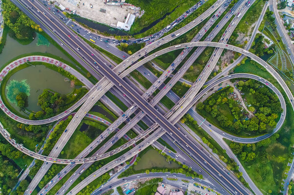 Aerial view car movement on traffic junction road with green tree park, Transport concept