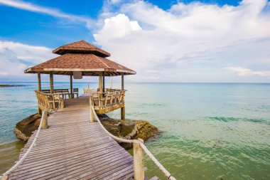 Mavi gökyüzü bulut gündoğumu ile tahta köprüden denize, Koh Kut, Tayland