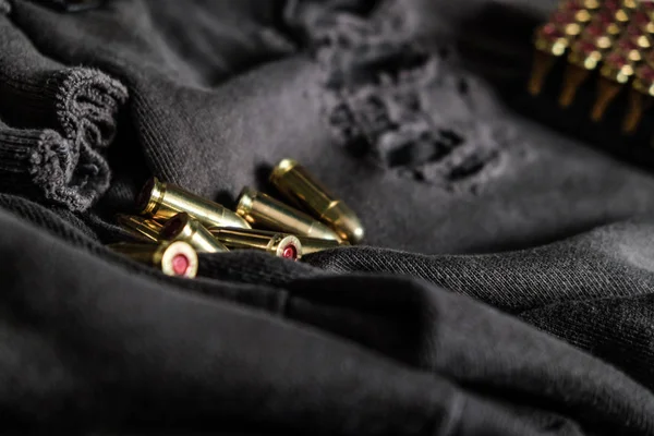 Full metal jacket 9mm ruger bullet on cloth texture arm object