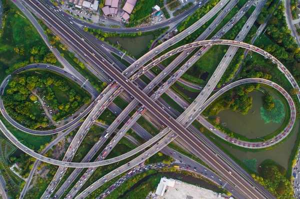 Intersection infinity sign traffic road with car and green park pond aerial view