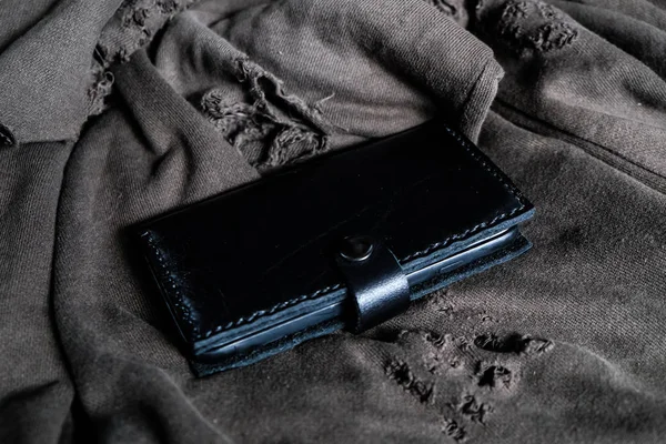 Leather phone case craftsmanship work on cloth background
