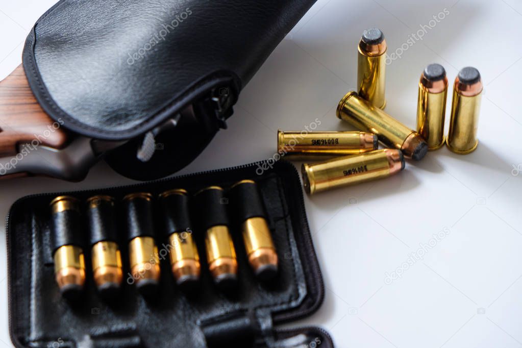 .44 magnum revolver handgun arm with metal bullet in leather bag isolated on white background