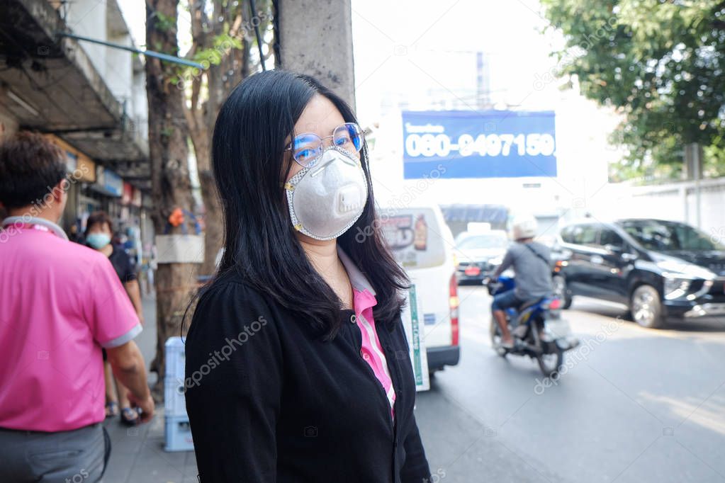 Women wearing protective mask n95 suffering air pollution on str