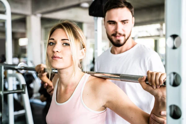 Sport man trainning women work out in fitness gym sport club