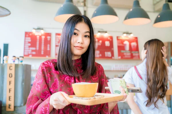 Happy casual beautiful women hold cup of latte coffee — Stock Photo, Image