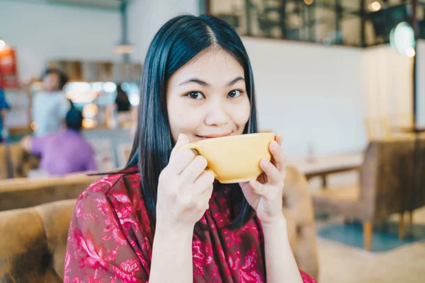 Happy casual beautiful women hold cup of latte coffee — Stock Photo, Image