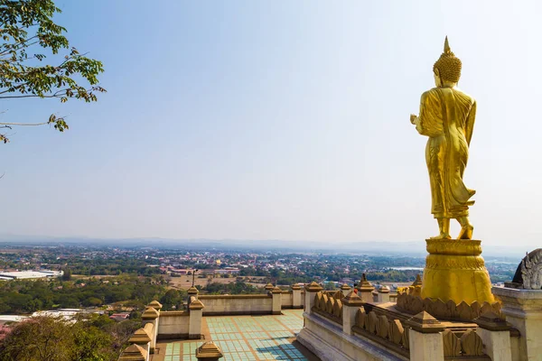 Golden buddhist statue on mountain in Nan