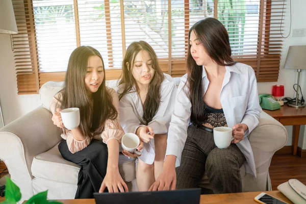 Business project team working together with laptop hold cup of c
